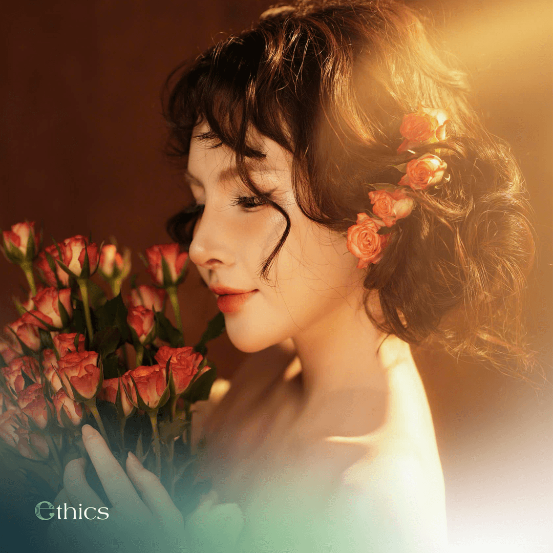 Radiant young woman holding a bouquet of roses one month after structural rhinoplasty